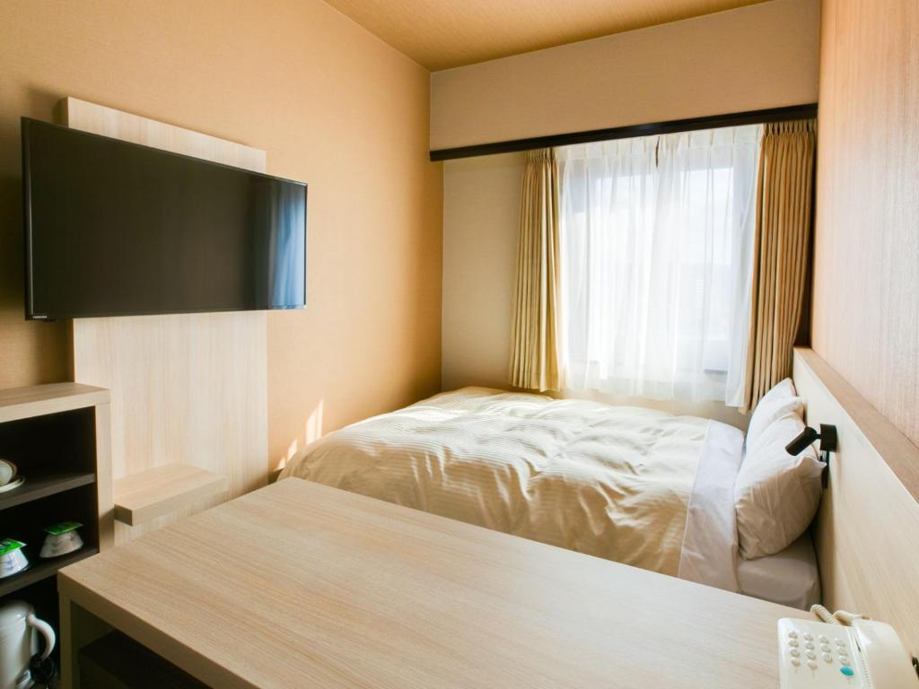 Postel nebo postele na pokoji v ubytování Maizuru Grand Hotel