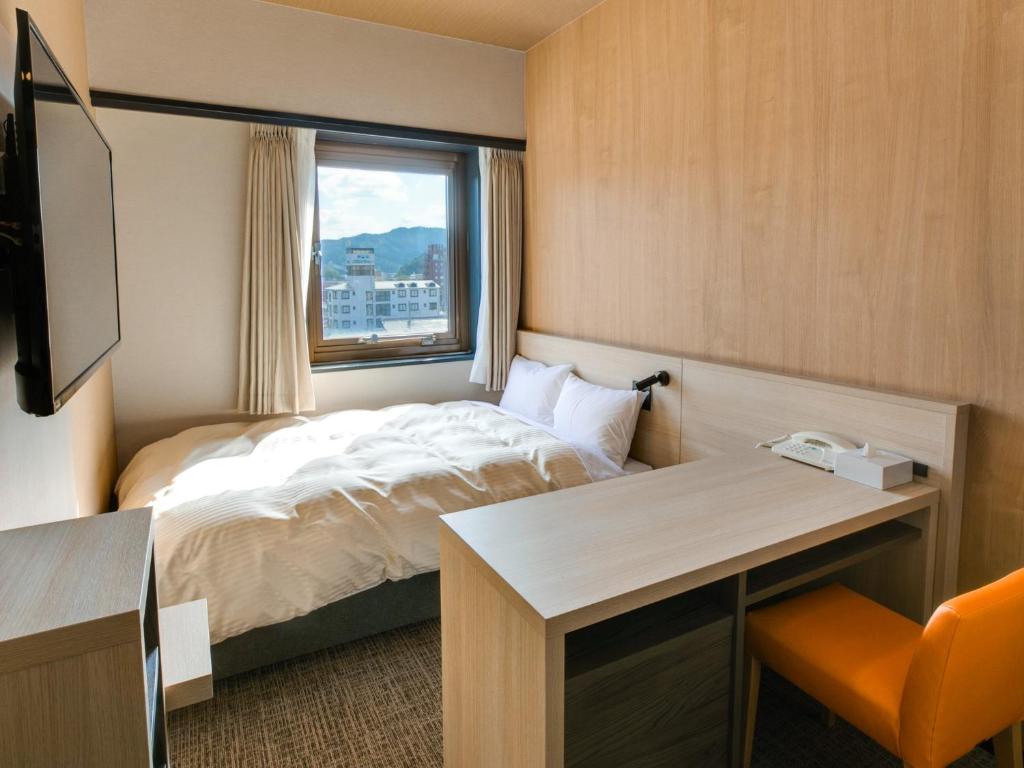 Postel nebo postele na pokoji v ubytování Maizuru Grand Hotel