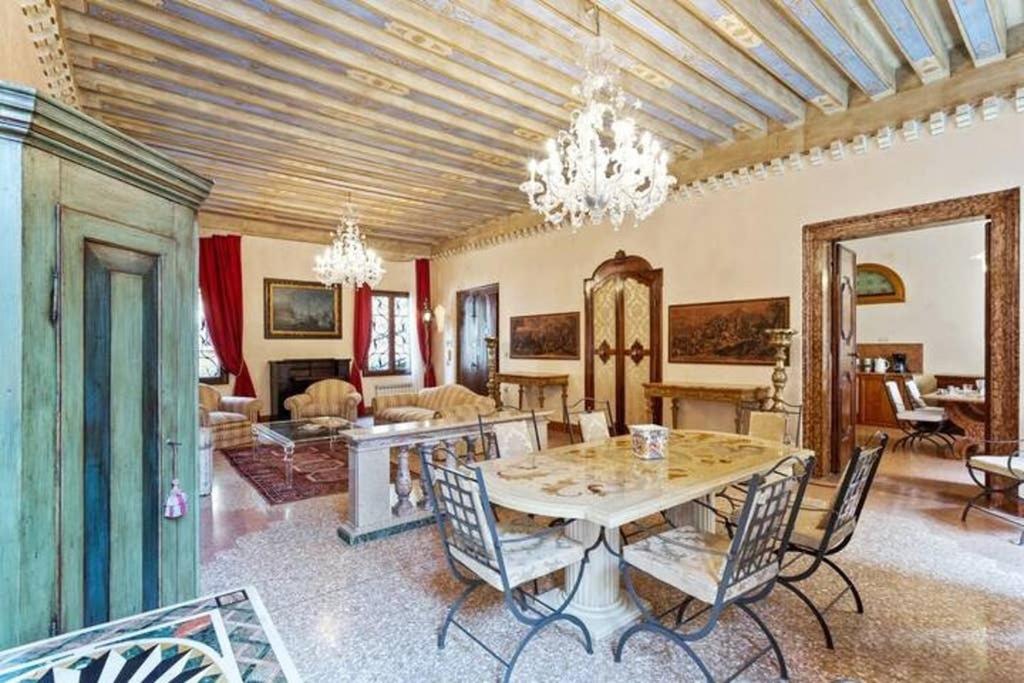 a large living room with a table and chairs at Doge Palace Luxury Apartment - Cannaregio in Venice