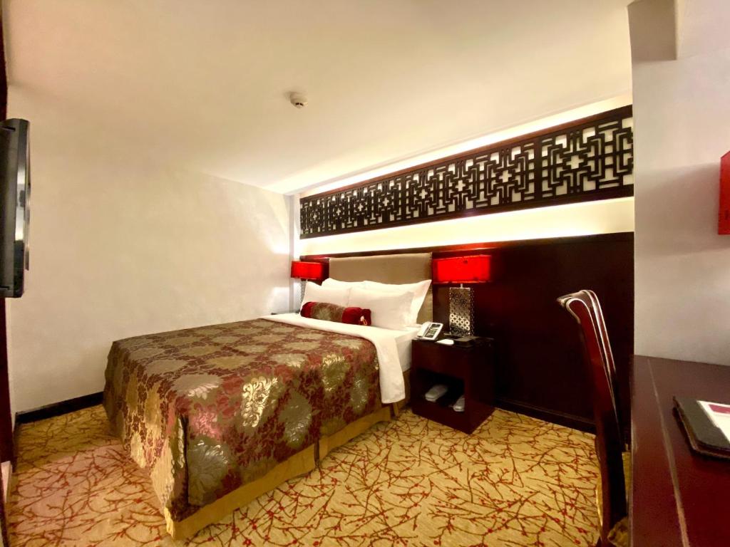 Postel nebo postele na pokoji v ubytování Hotel Metropole