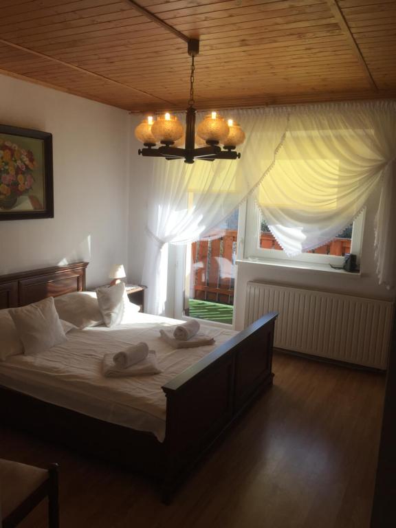 a bedroom with a large bed with towels on it at Willa Panorama in Szczyrk