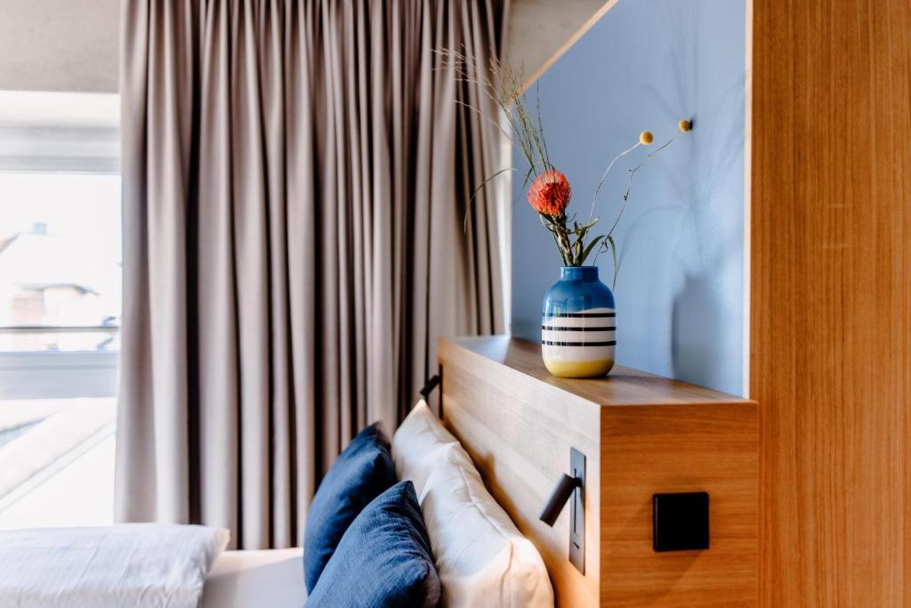 Cama ou camas em um quarto em THE FLAG West M.