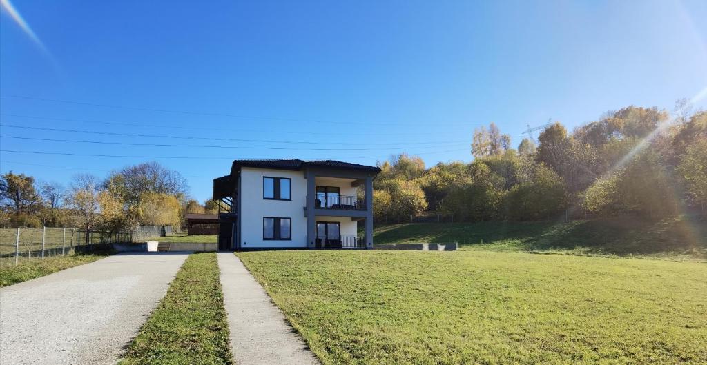 a house in the middle of a field at EdanApartments in Tohanu Nou