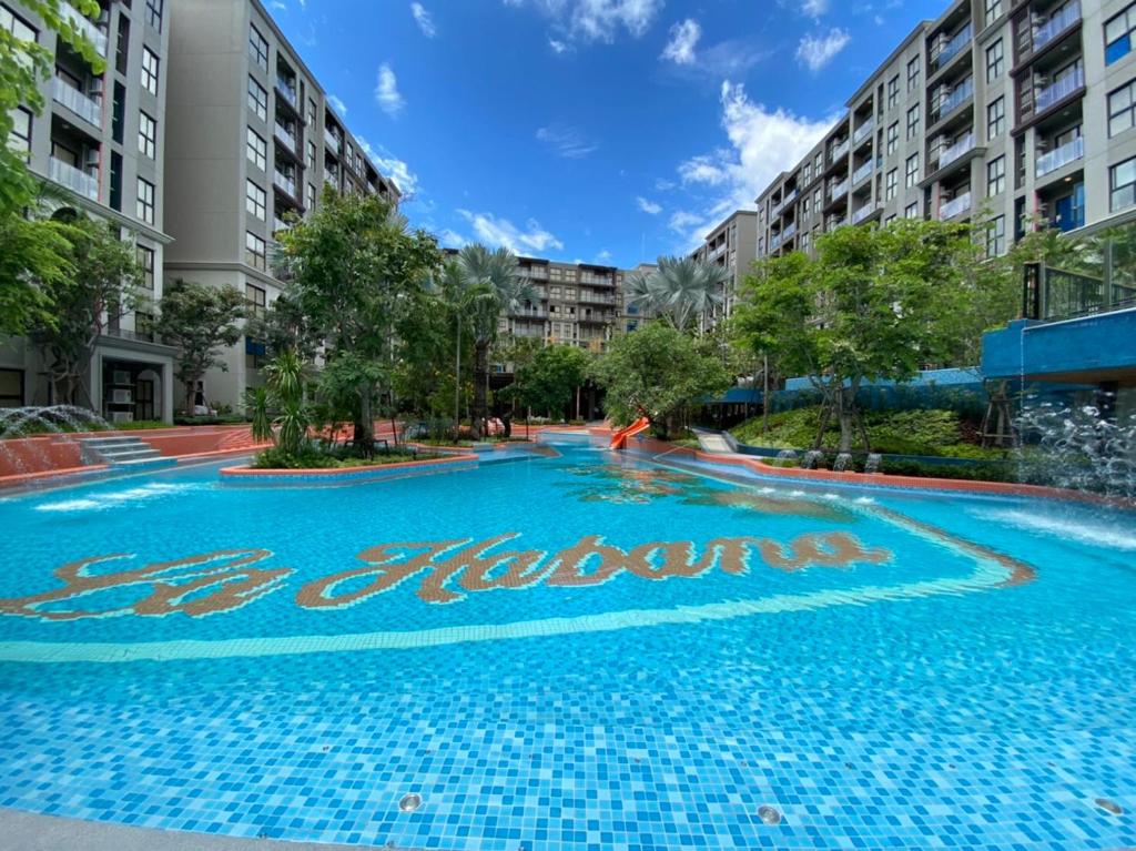 a swimming pool in the middle of a building at La HABANA Condo 135/500 in Hua Hin