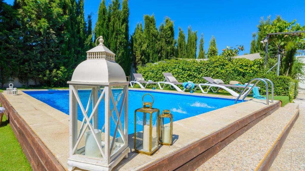 een witte lantaarn naast een zwembad bij Casa Entreolivos Casa y Cabana Cijuela by Ruralidays in Granada