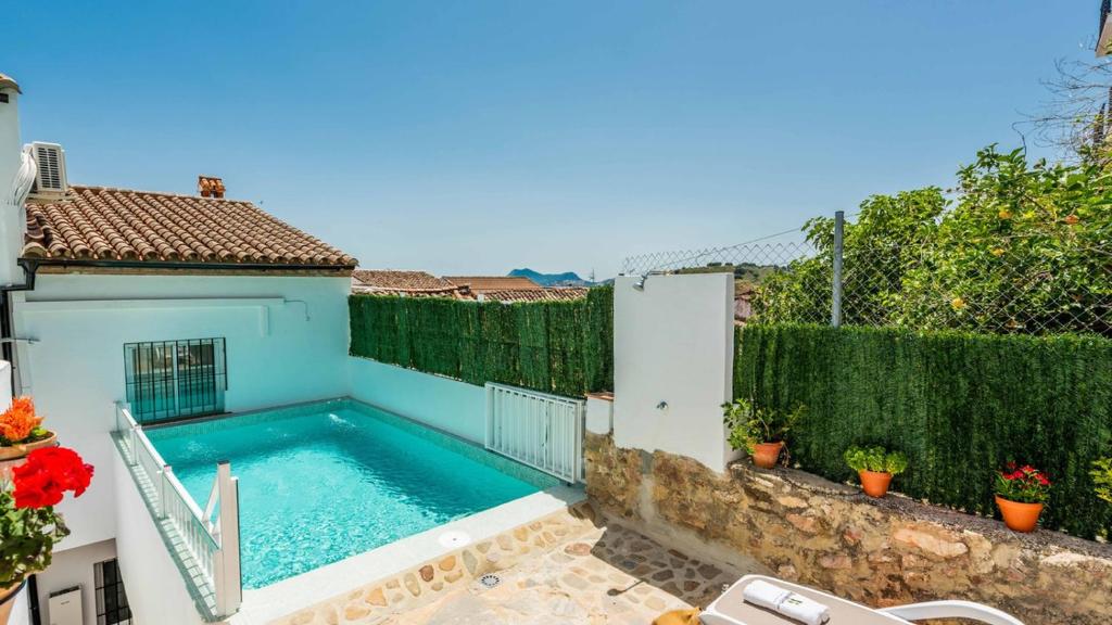 a swimming pool in the backyard of a house at Casa Los Bancales Cortes de la Frontera by Ruralidays in Cortes de la Frontera