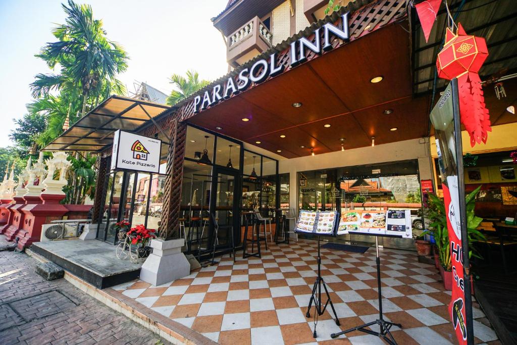 a store with a sign on the front of it at Parasol Inn Chiang Mai Old City in Chiang Mai