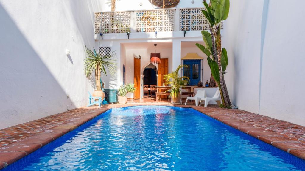 a swimming pool in the middle of a house at Villa El Patio Andaluz Velez-Malaga by Ruralidays in Vélez-Málaga