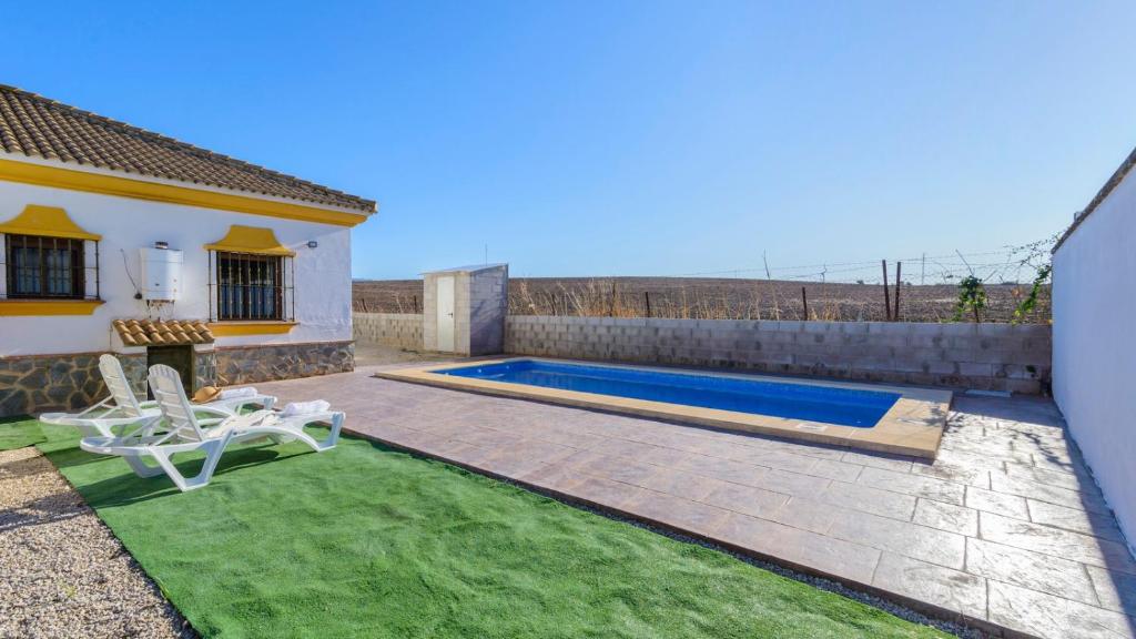 a backyard with a swimming pool and a house at Casa San Nicolas Algar by Ruralidays in Algar