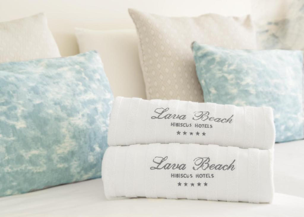 a pile of pillows sitting on a couch at Hotel Lava Beach in Puerto del Carmen