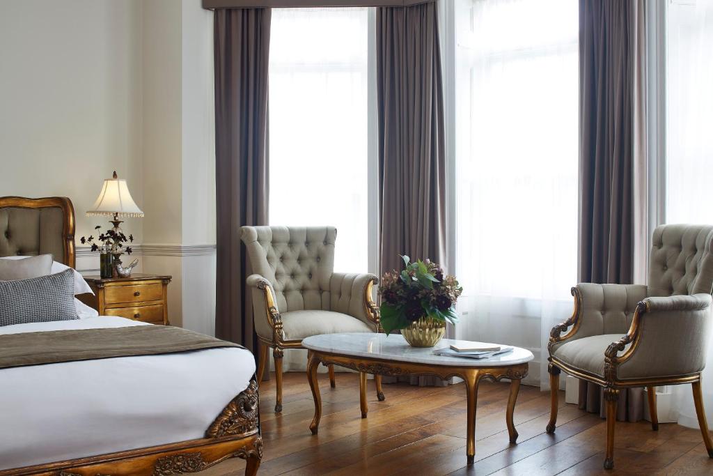 a living room filled with furniture and a window at The Westbridge Hotel Stratford in London