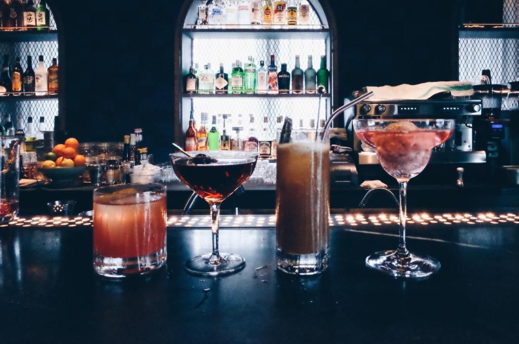 a group of cocktails sitting on top of a bar at Kimpton Da An Taipei- an IHG Hotel in Taipei