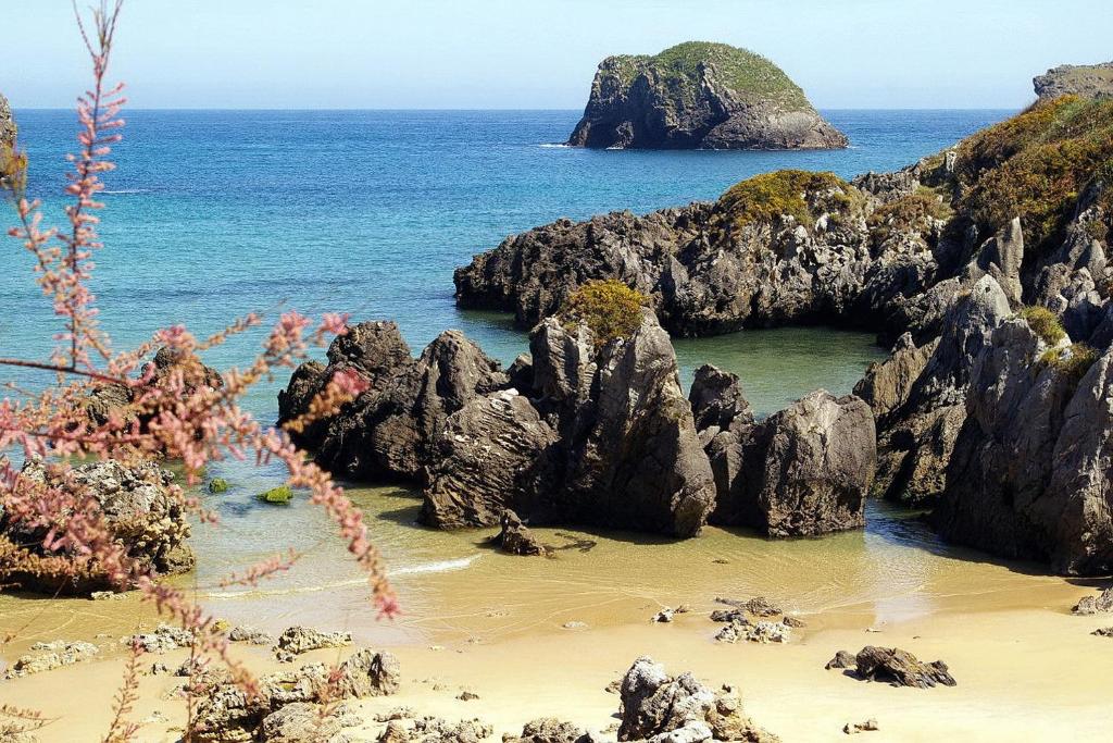 a view of a beach with rocks and the ocean at Miracielos in Barro de Llanes