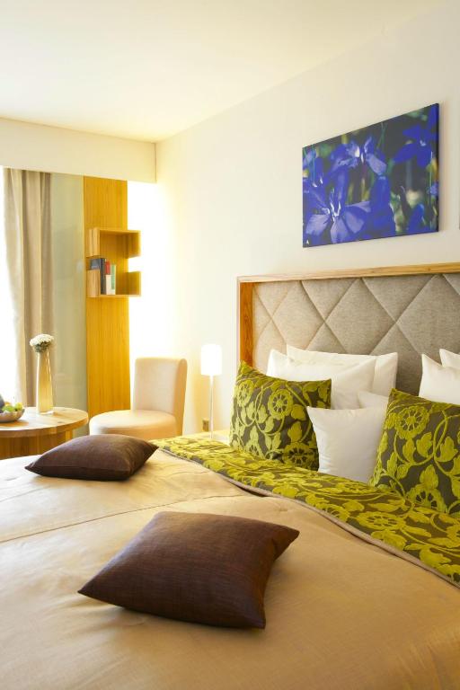 Postel nebo postele na pokoji v ubytování Hotel Maximilian