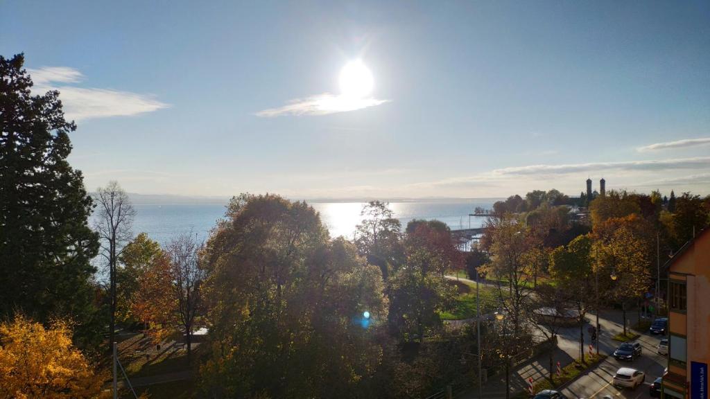 a view of a city with trees and the ocean at Apartment "SUN" in Friedrichshafen