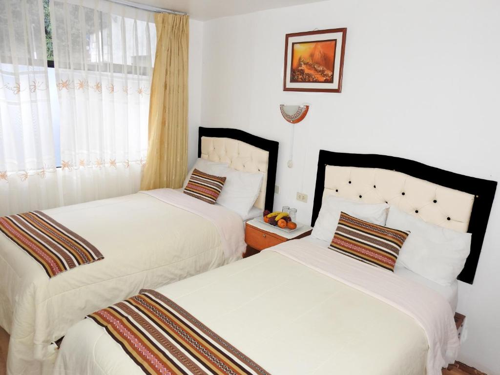 Postel nebo postele na pokoji v ubytování Hostal Encanto Machupicchu