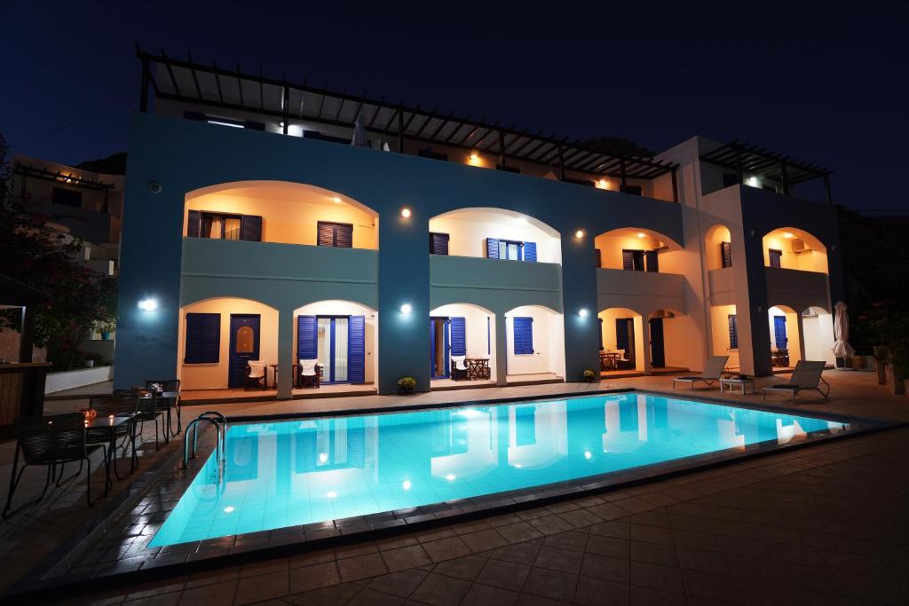 a swimming pool in front of a house at night at Sfakian Horizon in Khóra Sfakíon