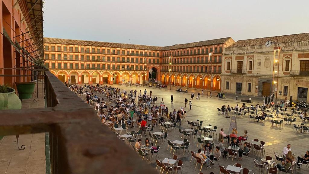 a group of people sitting in a courtyard in a building at Hostel Plaza Mayor Corredera in Córdoba