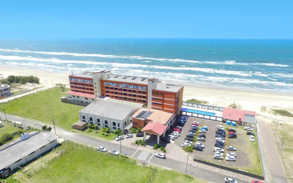 an aerial view of a hotel next to the beach at Hotel Araçá in Capão da Canoa