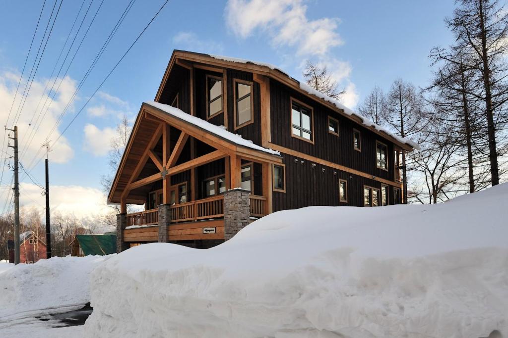 uma casa com um monte de neve em frente em Mangetsu - Vacation STAY 02526v em Niseko