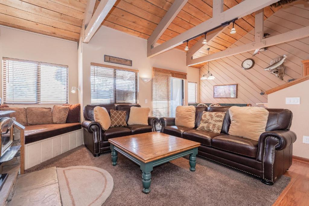 a living room with leather furniture and a table at Bigwood W #90 in Mammoth Lakes