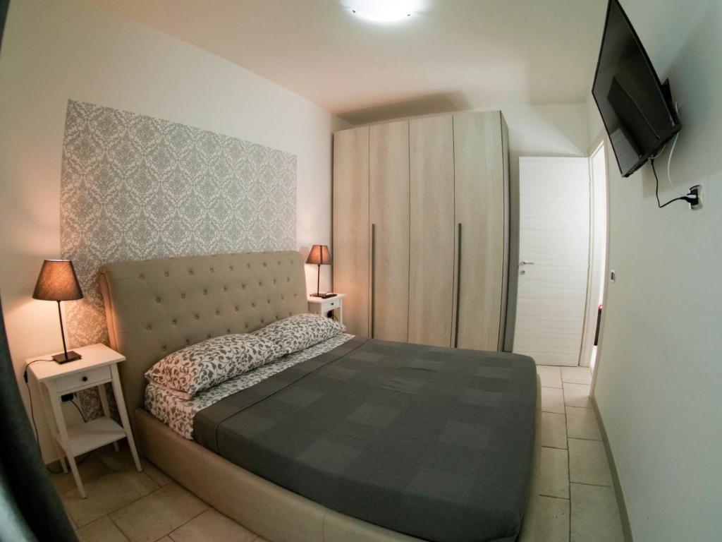 a bedroom with a bed and a television in it at Bed Borgo Antico in Nocera Inferiore