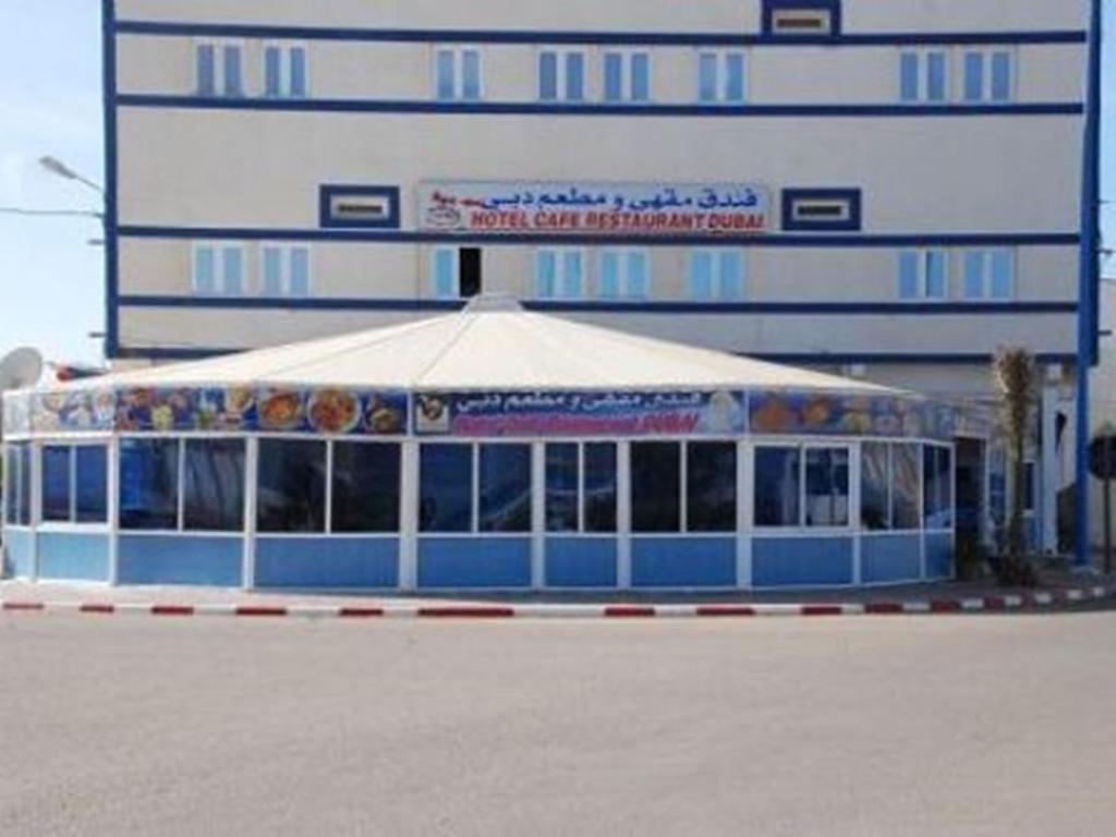 a food stand with a tent in front of a building at Hotel Dubai in Tan-Tan Plage