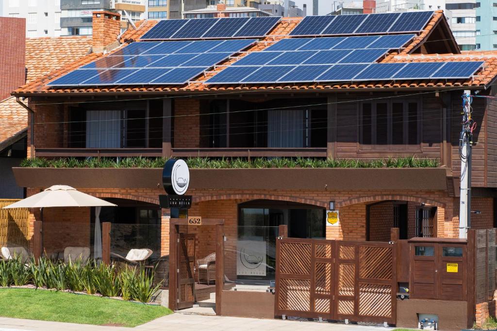 una casa con paneles solares encima en Pousada Lua Bella en Torres