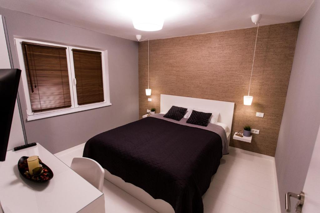 a bedroom with a bed and a table and window at The Retreat in Sinaia