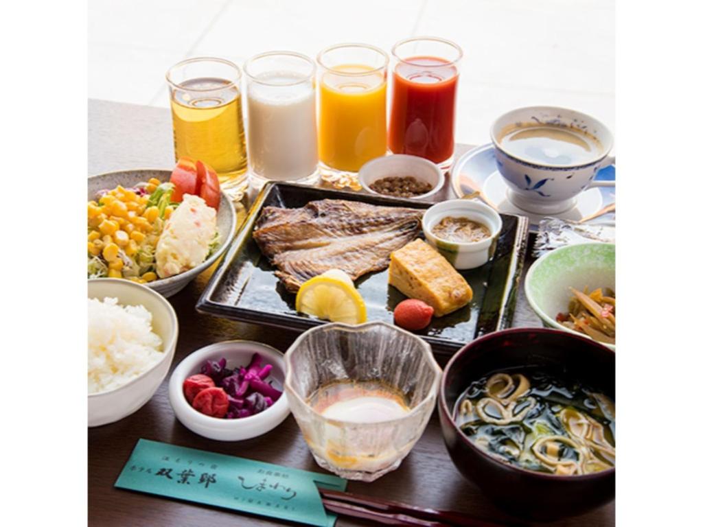 a table topped with different types of food and drinks at HOTEL FUTABATEI - Vacation STAY 03261v in Kido
