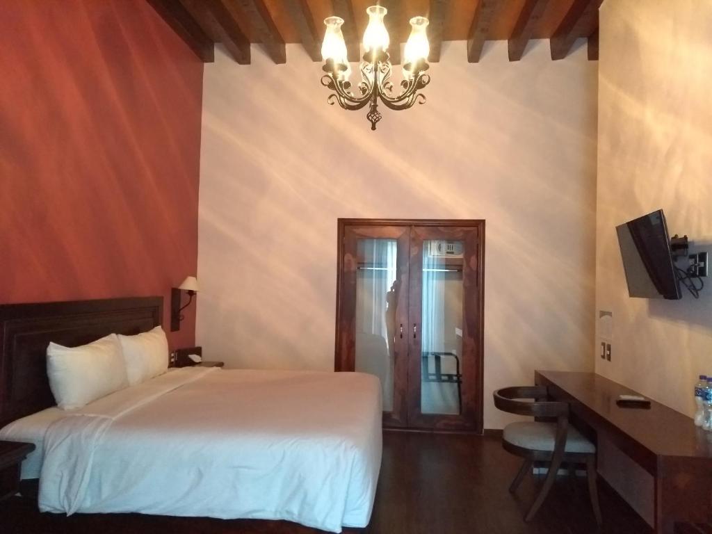 Postel nebo postele na pokoji v ubytování Hotel Alameda Centro Historico