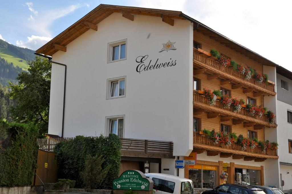 a building with a sign on the side of it at Gästehaus Pension Edelweiss in Kolsass