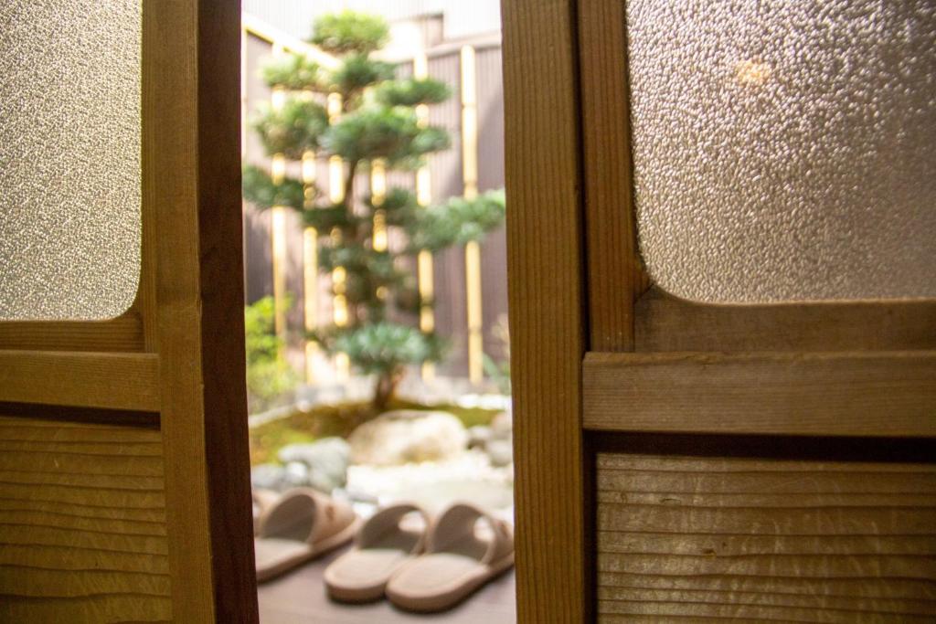 une paire de chaussures assise sur le sol par une porte dans l'établissement Ichikawa - Vacation STAY 03631v, à Kyoto