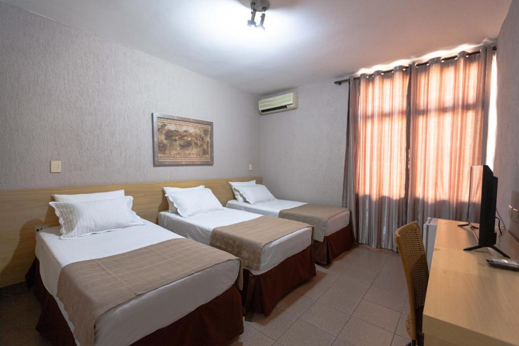 Postel nebo postele na pokoji v ubytování Hotel Foz do Iguaçu