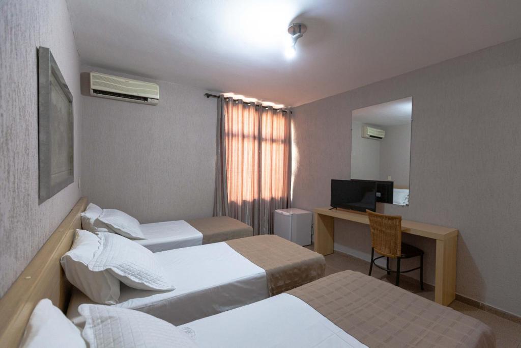 Postel nebo postele na pokoji v ubytování Hotel Foz do Iguaçu