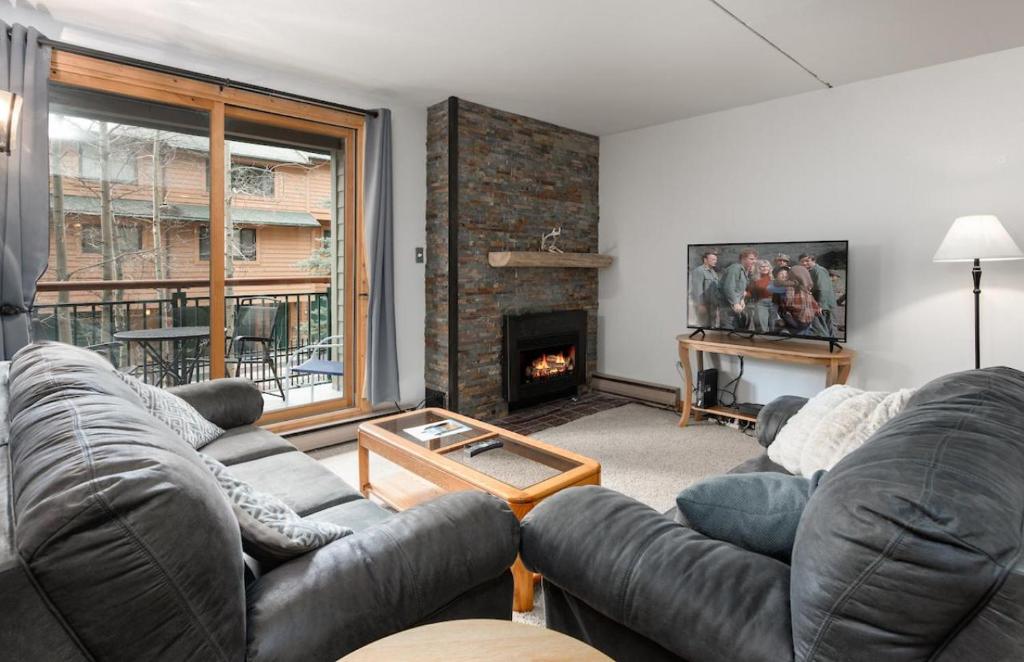 a living room with a couch and a fireplace at Trails End Condo in Breckenridge