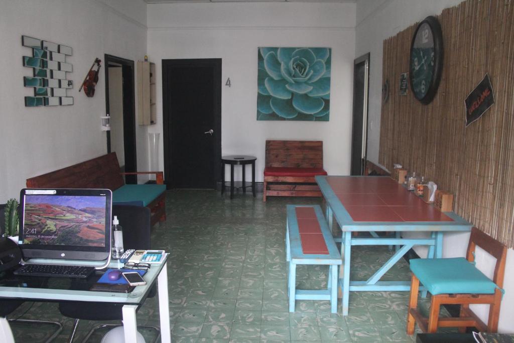 a room with a table and a laptop on a desk at Eden`s Garden Hostel in Panama City