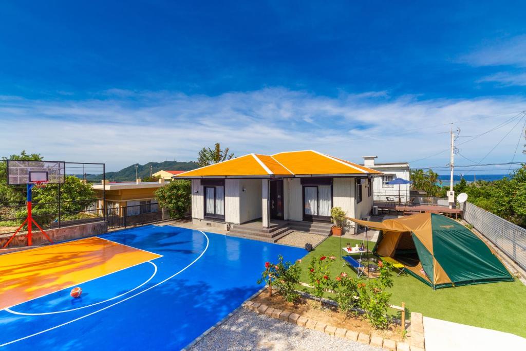 a house with a swimming pool and a basketball hoop at Regina Ishigaki Kabira Sky / Two-Bedroom House in Kabira