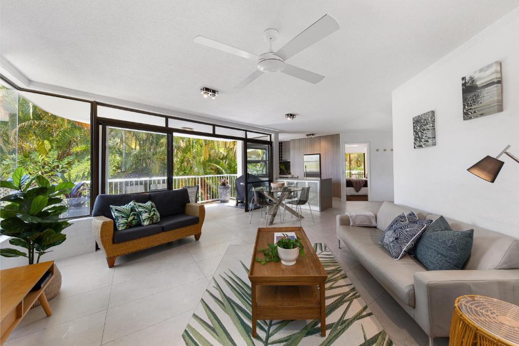 a living room with a couch and a table at Naousa II Apartment 5, Little Cove in Noosa Heads