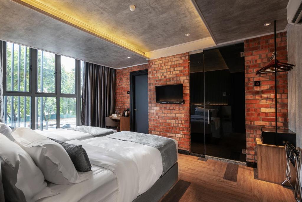 Postel nebo postele na pokoji v ubytování A&R Urban Hotel