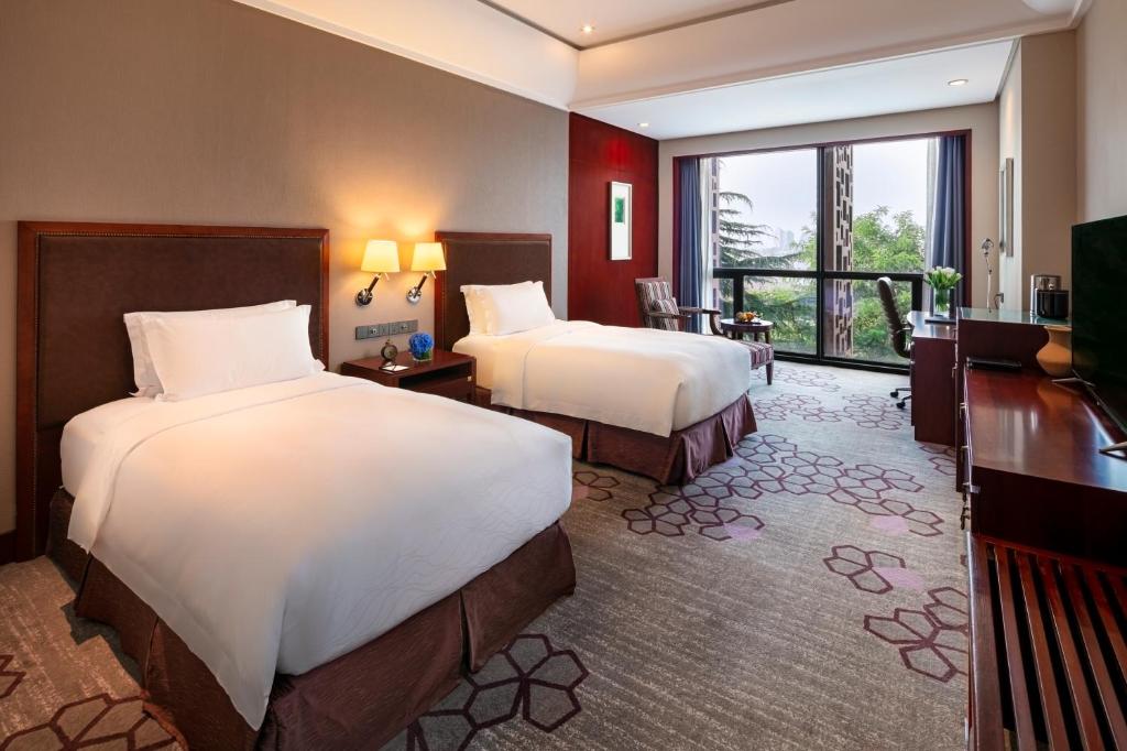 Postel nebo postele na pokoji v ubytování Jin Jiang International Hotel Xi'an