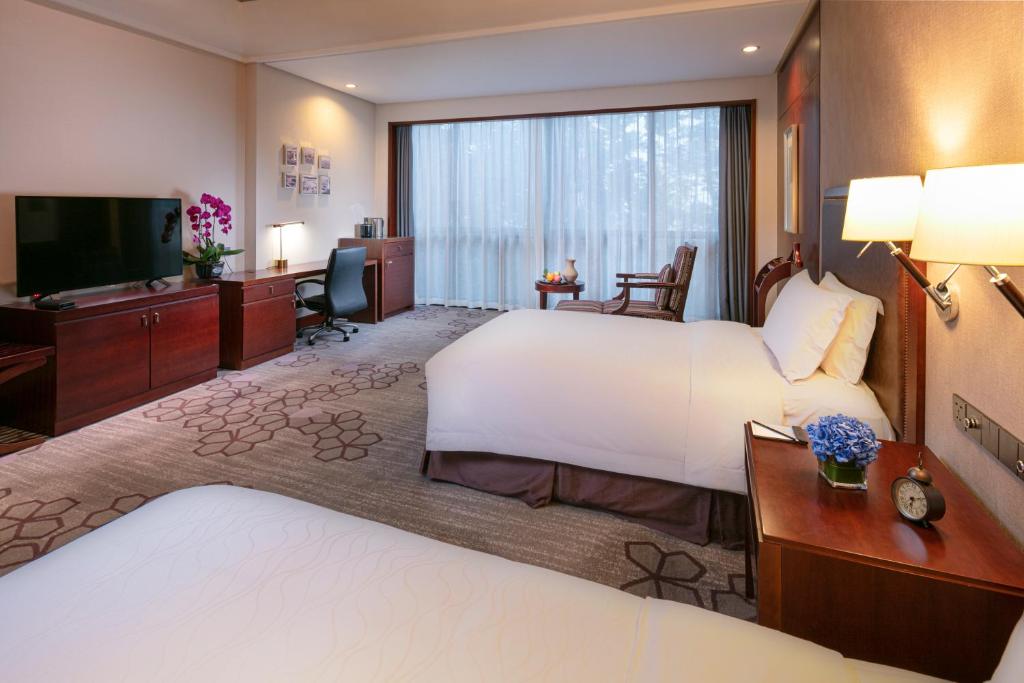 Postel nebo postele na pokoji v ubytování Jin Jiang International Hotel Xi'an