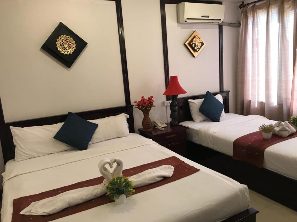 Postel nebo postele na pokoji v ubytování Vientiane SP Hotel