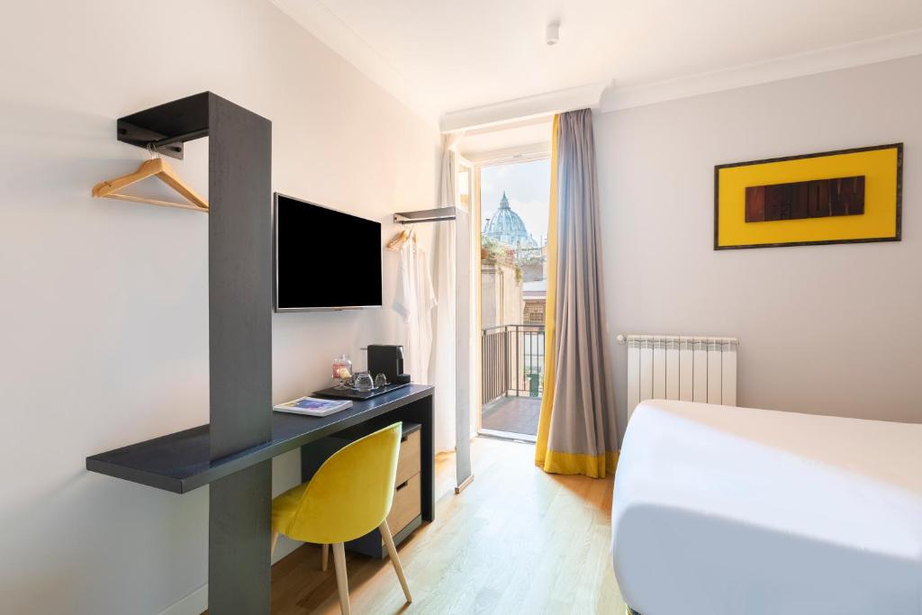 a hotel room with a bed and a desk with a tv at Residenza Palline in Rome