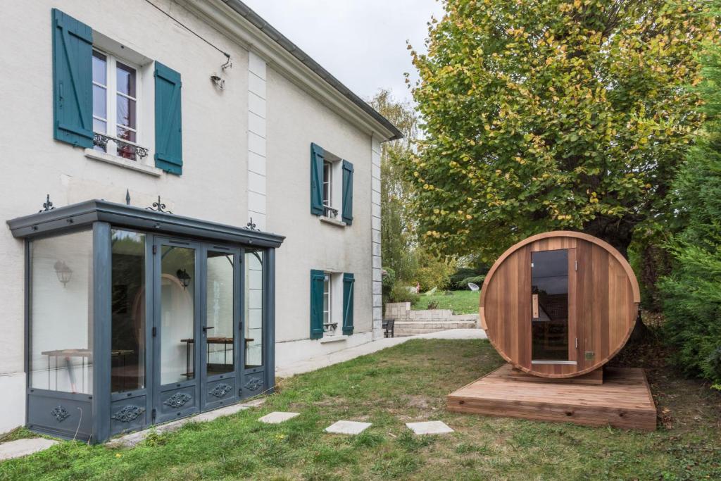 a wooden orb sits next to a house at Standing cottage in Disneyland in Chalifert