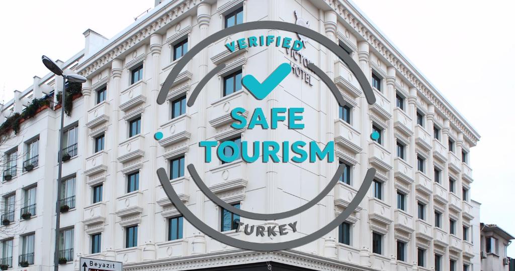 a large white building with a sign on it at Victory Hotel & Spa Istanbul in Istanbul