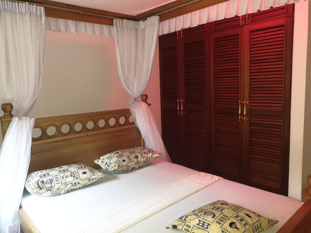 Postel nebo postele na pokoji v ubytování Karibuni palace mtwapa