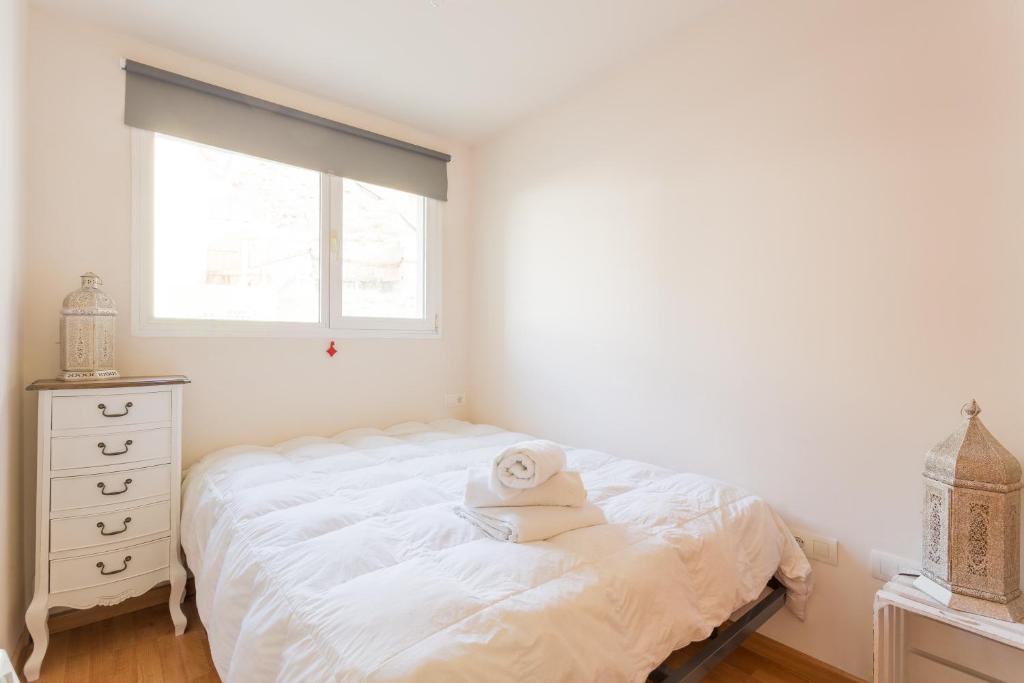 Łóżko lub łóżka w pokoju w obiekcie Apartamentos Sierra Nevada Prime Bluettravel