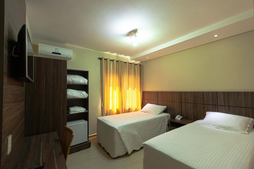 Postel nebo postele na pokoji v ubytování Hotel Foz do Iguaçu