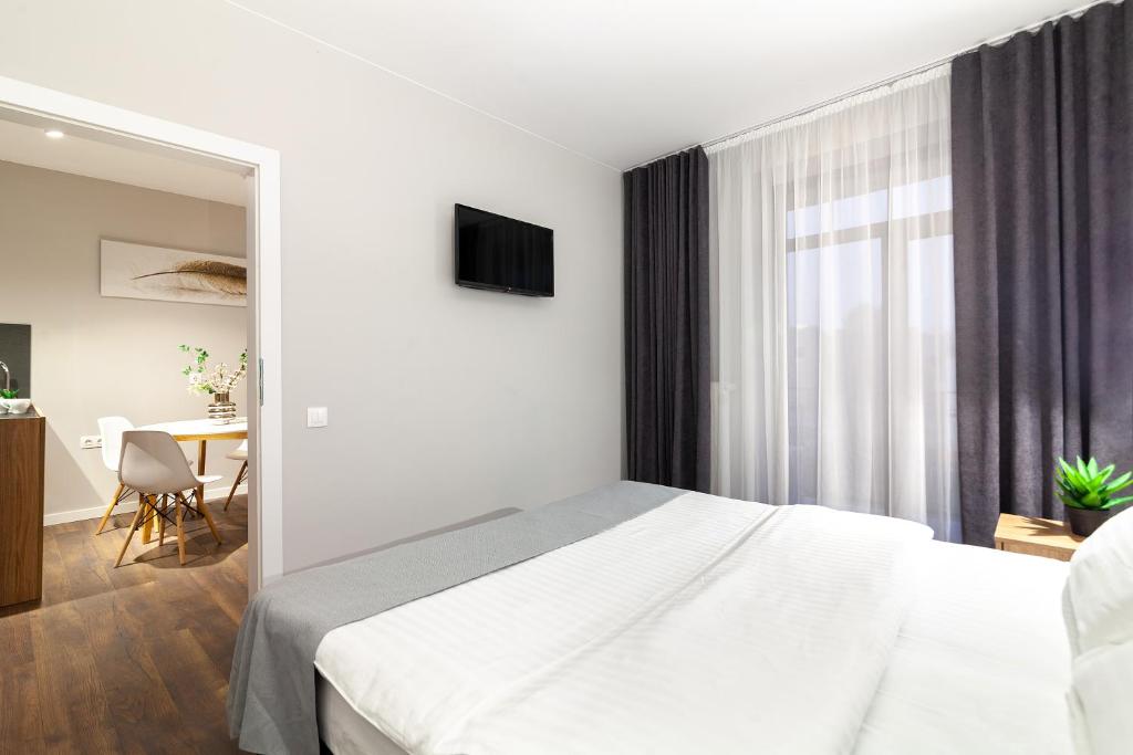 Postel nebo postele na pokoji v ubytování AUSTRIAN APART HOTEL